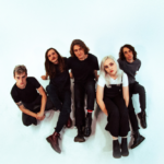 A photograph of the five members of Flipturn sitting against a white backdrop.