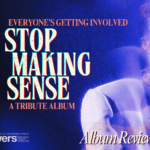 A grainy, film photo of David Byrne in the iconic oversized suit he appears in for "Stop Making Sense." Behind him is a grainy blue background with a line of orange text that reads "Everyone's Getting Involved." Below that, white text reads "Stop Making Sense." And a third line has orange text reading "A tribute album."
