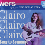 A photograph of Claire Cottrill, better known as Clairo, strumming a white electric guitar. The top third of the background has the three horizontal stripes of the bisexual pride flag (pink, purple, blue) with text that reads "WERS 88.9 Pick of the Week." The rest of the background is light blue and reads "Clairo" three times and "Sexy to Someone"