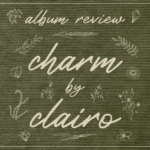 A collage illustration made to look like a forest green patch of fabric with white stitched embroidery of flowers and lettering, which reads: "Album Review, Charm by Clairo"