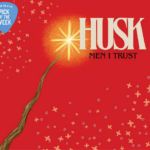 A bright red background is covered with various yellow stars and a wooden wand with a light at the end. In front of the light are the word "Husk" and "Men I Trust."