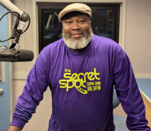 DJ Mo Wilks wearing a new The Secret Spot tee (front)