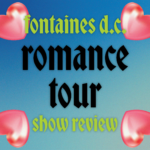 A gradient green and blue background has four 3D pink hearts in the corner. Text reads "Fontaines D.C. romance tour show review."