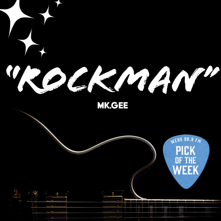 A black electric guitar sits low on a dark background. Text reads "ROKCMAN" and "Mk.gee."