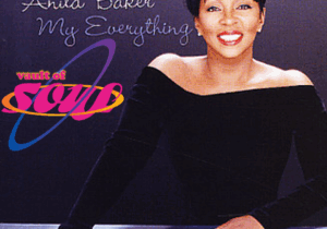 Image of Anita Baker wearing a black top looking forward. Anita Baker is spelled out in white next to her and Vault of Soul is written in purple, yellow, and pink underneath.
